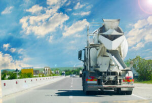 Ready-mix concrete truck leaving an active operation for delivery